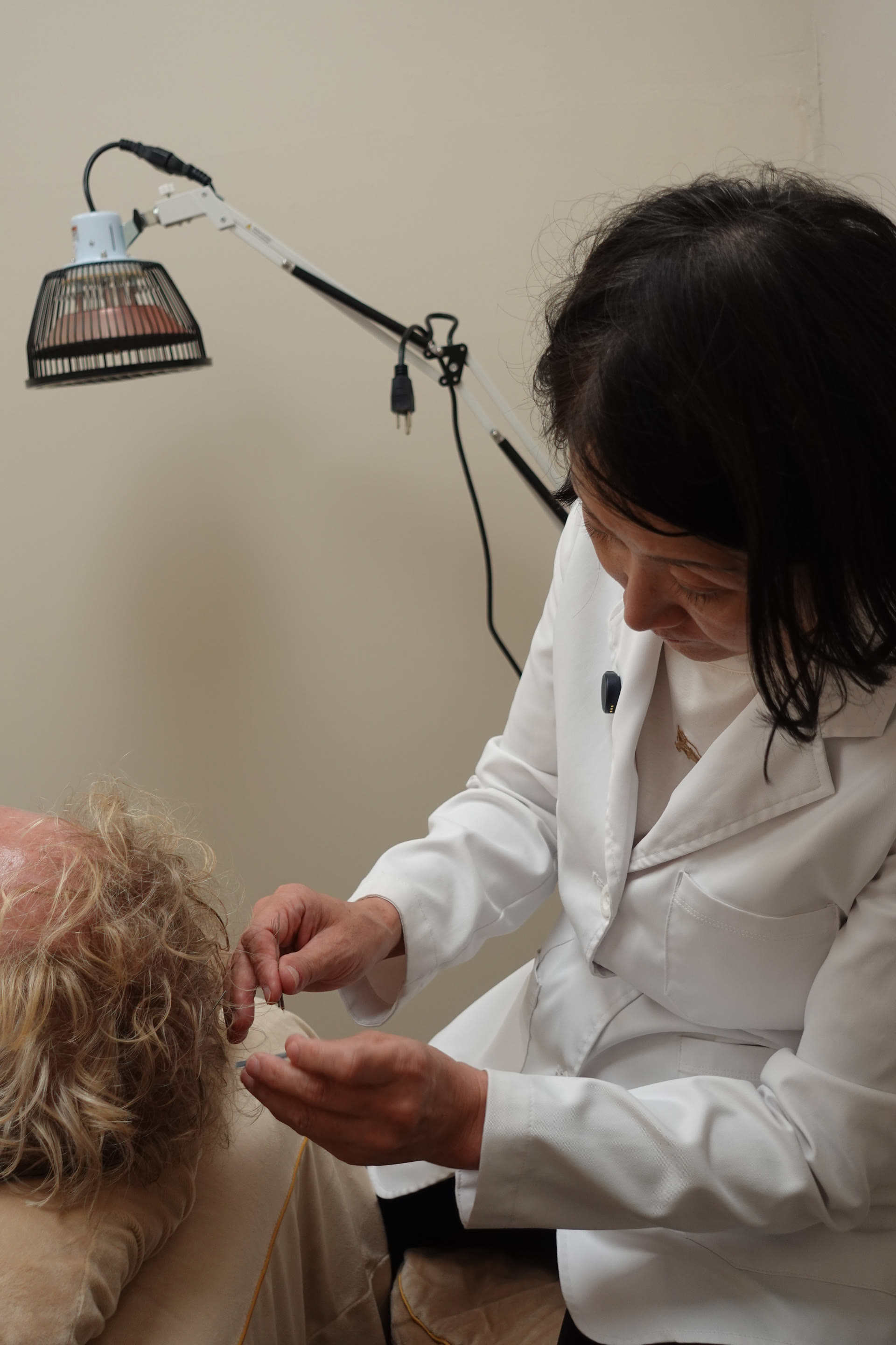 Dr. Lucy Brooks placing acupuncture needles